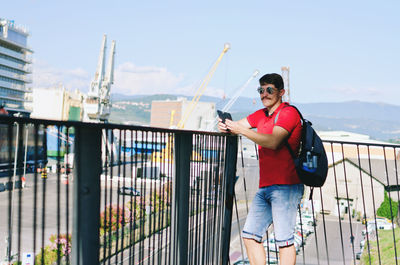 Young happy handsome bearded man, tourist, hipster walking in old city of koper. summer vacation