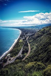 Aerial view of road by sea against sky