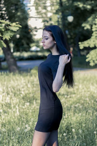 Young woman standing on field