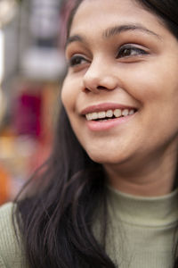 Close-up portrait of a smiling young woman