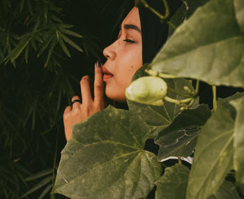 Close-up of human hand on leaves