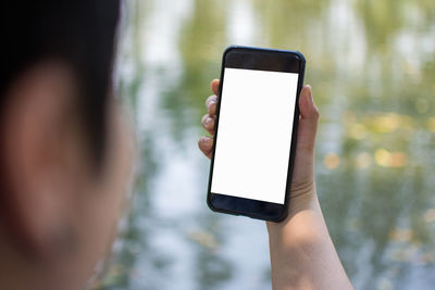 Cropped image of woman holding mobile phone