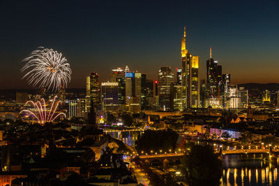 Fireworks mainfest frankfurt in front of illuminated city skyline