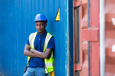 Portrait of man leaning on container