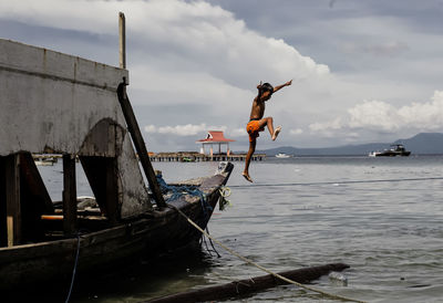 Asian children playing in the water on the beach following a heat wave that hit north maluku