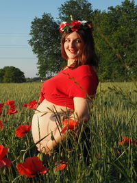 Portrait of beautiful woman on grassy field