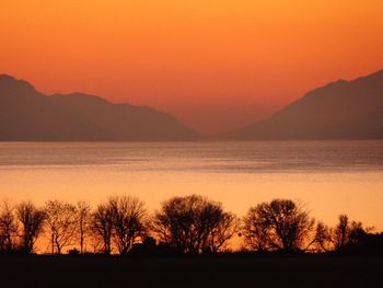 Scenic view of silhouette mountains against sky during sunset