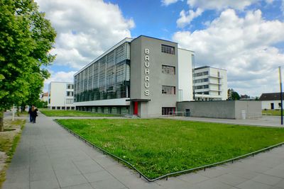 Buildings in city against cloudy sky