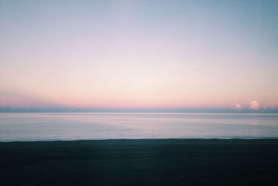 Scenic view of sea against clear sky at sunset