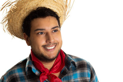 Portrait of smiling young man against white background