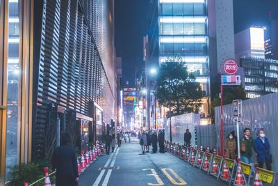 People on city street at night