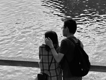 Rear view of couple standing in water