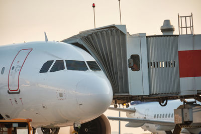 Plane with jetway in the evening. passenger boarding. airport ground service and maintenance