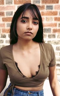 Portrait of beautiful woman standing against wall