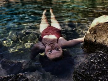 Portrait of woman laying in sea