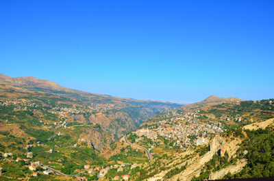 Scenic view of mountains against clear blue sky