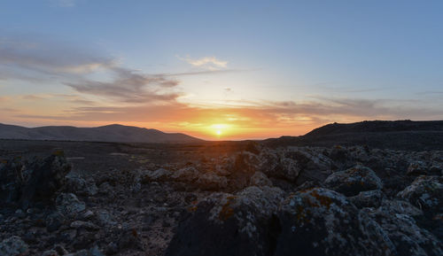 Scenic view of rocky mountains against sky during sunset