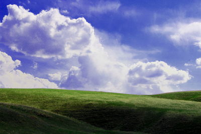 Scenic view of green landscape against sky