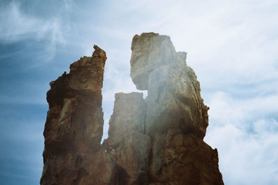 Low angle view of rock formation against sky