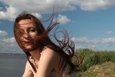 Portrait of woman against sky