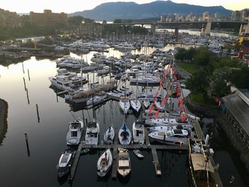 High angle view of boats moored at harbor in city