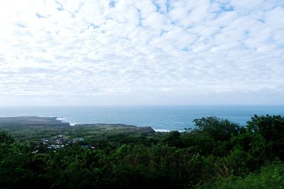 Scenic view of sea and mountains against sky
