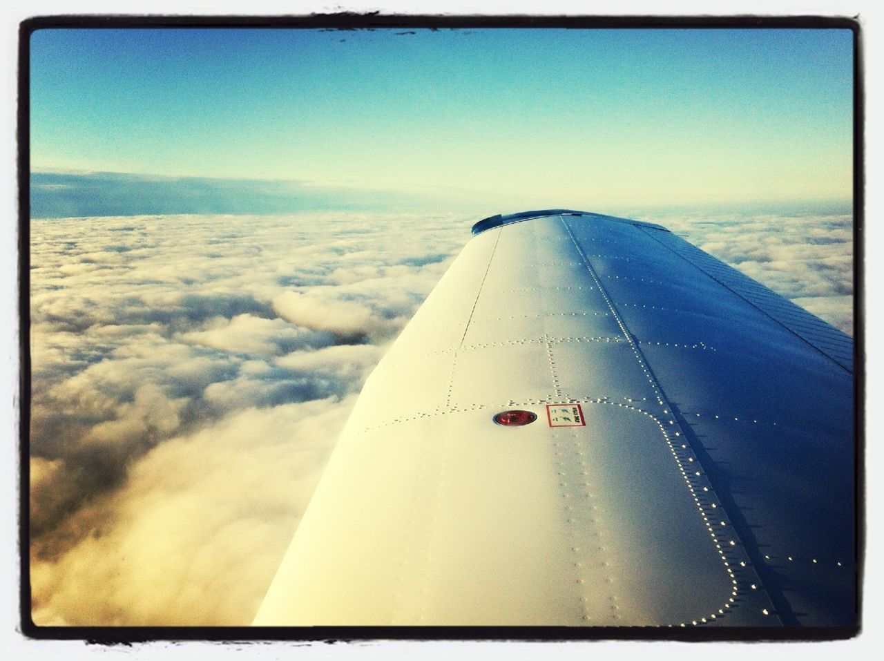 transportation, sky, cropped, transfer print, part of, mode of transport, aircraft wing, airplane, auto post production filter, travel, cloud - sky, air vehicle, journey, cloud, no people, text, day, scenics, blue, nature