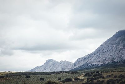 Scenic view of mountains against cloudy sky