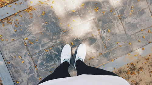 Low section of person standing on tiled floor