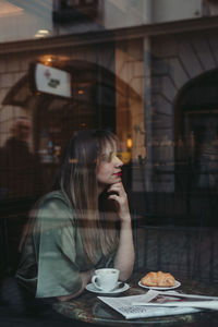 Woman with coffee cup on table