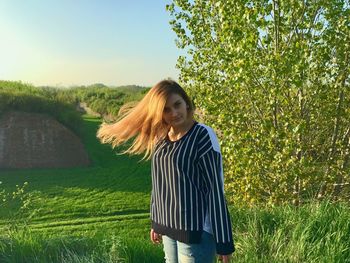 Young woman standing on field