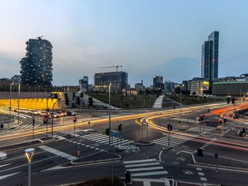 Aerial view of illuminated city buildings against sky