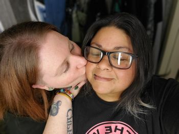 Lesbian couple in love with cheek kiss