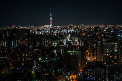 High angle view of illuminated buildings in city at night