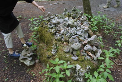 Low section of person standing on stones