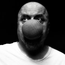 Close-up portrait of man against black background