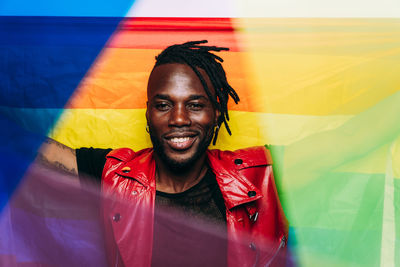 Portrait of man with rainbow flag