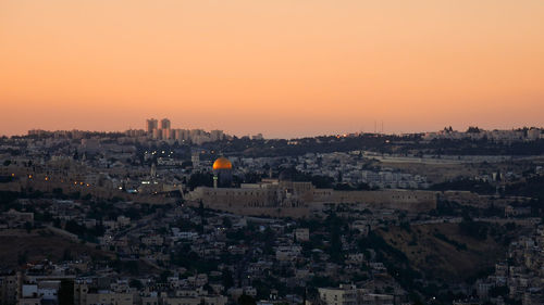 Aerial view of cityscape against sky during sunset
