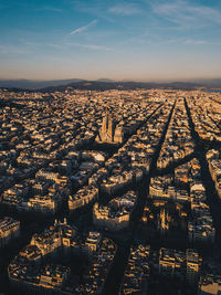 Aerial view of buildings in city during sunset