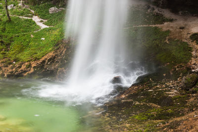 Scenic view of waterfall against sky