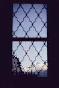 Close-up of chainlink fence against sky