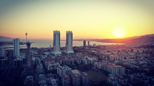 High angle view of buildings in city during sunset