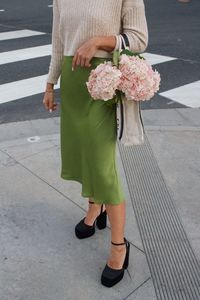 Low section of woman standing on street