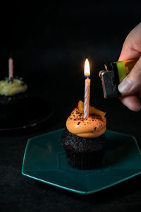 Close-up of hand with birthday cake