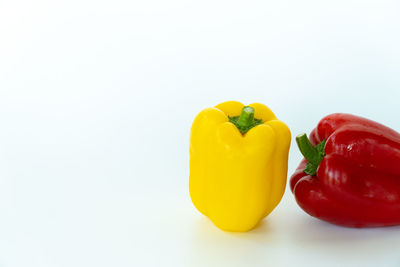 Close-up of yellow bell peppers on white background