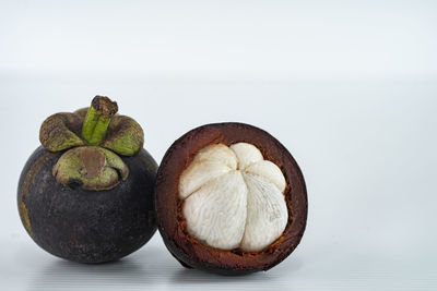 Close-up of fruits on table against white background