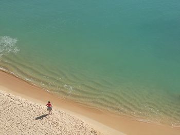 Aerial view of woman standing at beach