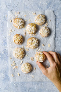 Homemade cookies with nuts and sugar over delcate blue background. top view. copy space.