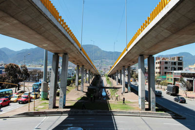 Bridge over road in city against clear sky