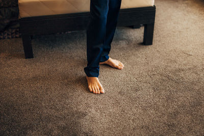 Low section of man standing on floor